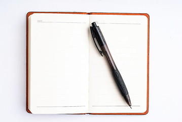 Image showing notepad with pen isolated