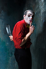 Image showing The crazy clown holding a knife on dack. Halloween concept