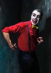 Image showing Terrible clown and Halloween theme: Crazy red clown in a shirt with suspenders