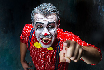 Image showing Terrible clown and Halloween theme: Crazy red clown in a shirt with suspenders