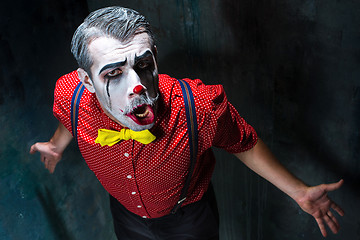 Image showing Terrible clown and Halloween theme: Crazy red clown in a shirt with suspenders