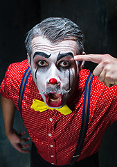 Image showing Terrible clown and Halloween theme: Crazy red clown in a shirt with suspenders