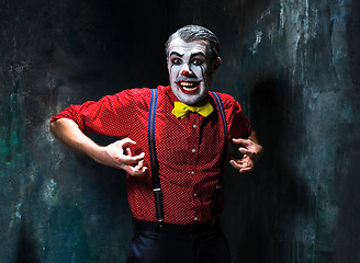 Image showing Terrible clown and Halloween theme: Crazy red clown in a shirt with suspenders