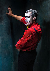 Image showing Terrible clown and Halloween theme: Crazy red clown in a shirt with suspenders