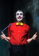 Image showing Terrible clown and Halloween theme: Crazy red clown in a shirt with suspenders