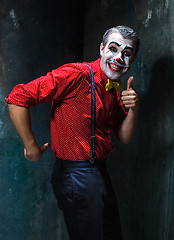 Image showing Terrible clown and Halloween theme: Crazy red clown in a shirt with suspenders