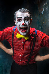 Image showing Terrible clown and Halloween theme: Crazy red clown in a shirt with suspenders