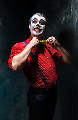 Image showing Terrible clown and Halloween theme: Crazy red clown in a shirt with suspenders