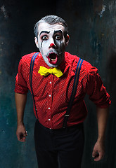 Image showing Terrible clown and Halloween theme: Crazy red clown in a shirt with suspenders