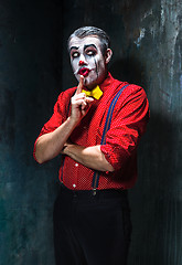 Image showing Terrible clown and Halloween theme: Crazy red clown in a shirt with suspenders