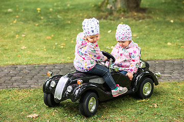 Image showing The little baby girl playing at car