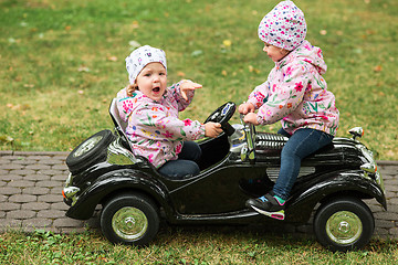 Image showing The little baby girl playing at car