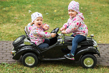 Image showing The little baby girl playing at car