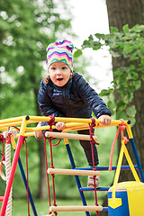 Image showing The little baby girl playing at outdoor playground