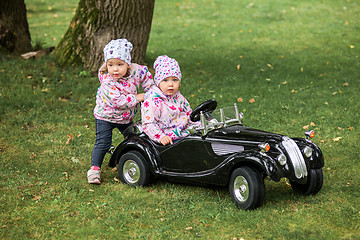 Image showing The little baby girl playing at car