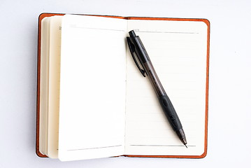 Image showing notepad with pen isolated