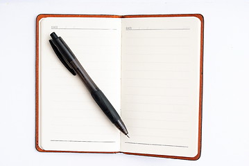 Image showing notepad with pen isolated