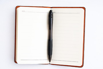 Image showing notepad with pen isolated