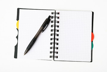 Image showing notepad with pen isolated