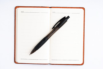 Image showing notepad with pen isolated