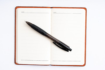 Image showing notepad with pen isolated