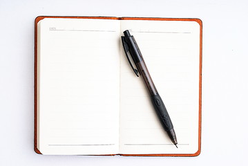 Image showing notepad with pen isolated