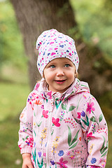 Image showing The little baby girl standing at park