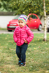 Image showing The little baby girl standing at park