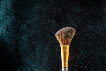 Image showing Item makeup - brush on black background with eye shadows