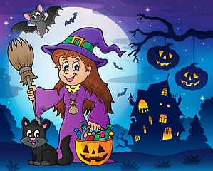 Image showing Cute witch and cat in Halloween scenery