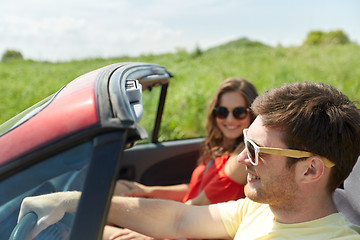 Image showing happy couple driving in cabriolet car at country