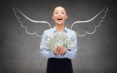 Image showing businesswoman with dollar money and angel wings