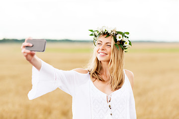 Image showing happy young woman taking selfie by smartphone