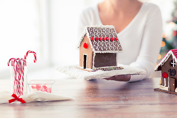 Image showing close up of woman showing gingerbread house