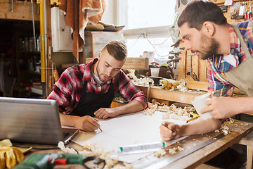 Image showing carpenters with laptop and blueprint at workshop