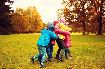 Image showing group of happy children hugging in autumn park