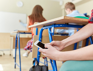 Image showing student boy with smartphone texting at school