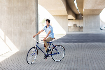 Image showing young hipster man riding fixed gear bike