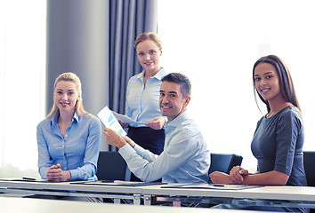 Image showing smiling business people with papers in office