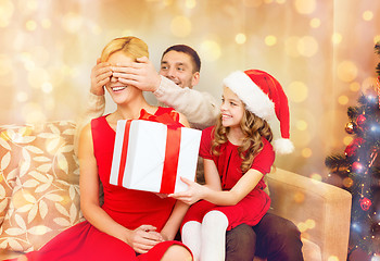 Image showing father and daughter surprise mother with gift box