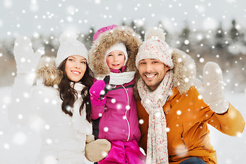 Image showing happy family waving hands outdoors in winter