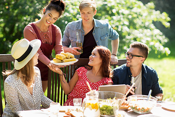 Image showing happy friends having dinner at summer garden party