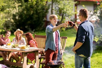 Image showing friends drinking beer at summer barbecue party