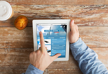 Image showing close up of hands with business news on tablet pc