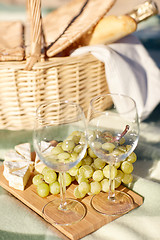 Image showing picnic basket with wine glasses and food on beach