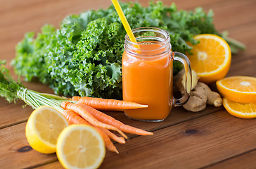 Image showing glass jug of carrot juice, fruits and vegetables