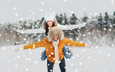 Image showing happy couple having fun over winter background