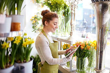 Image showing woman with tablet pc computer at flower shop
