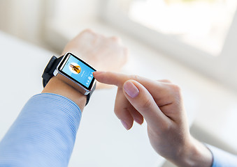 Image showing close up of hands with music player on smart watch