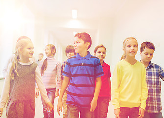 Image showing group of smiling school kids walking in corridor
